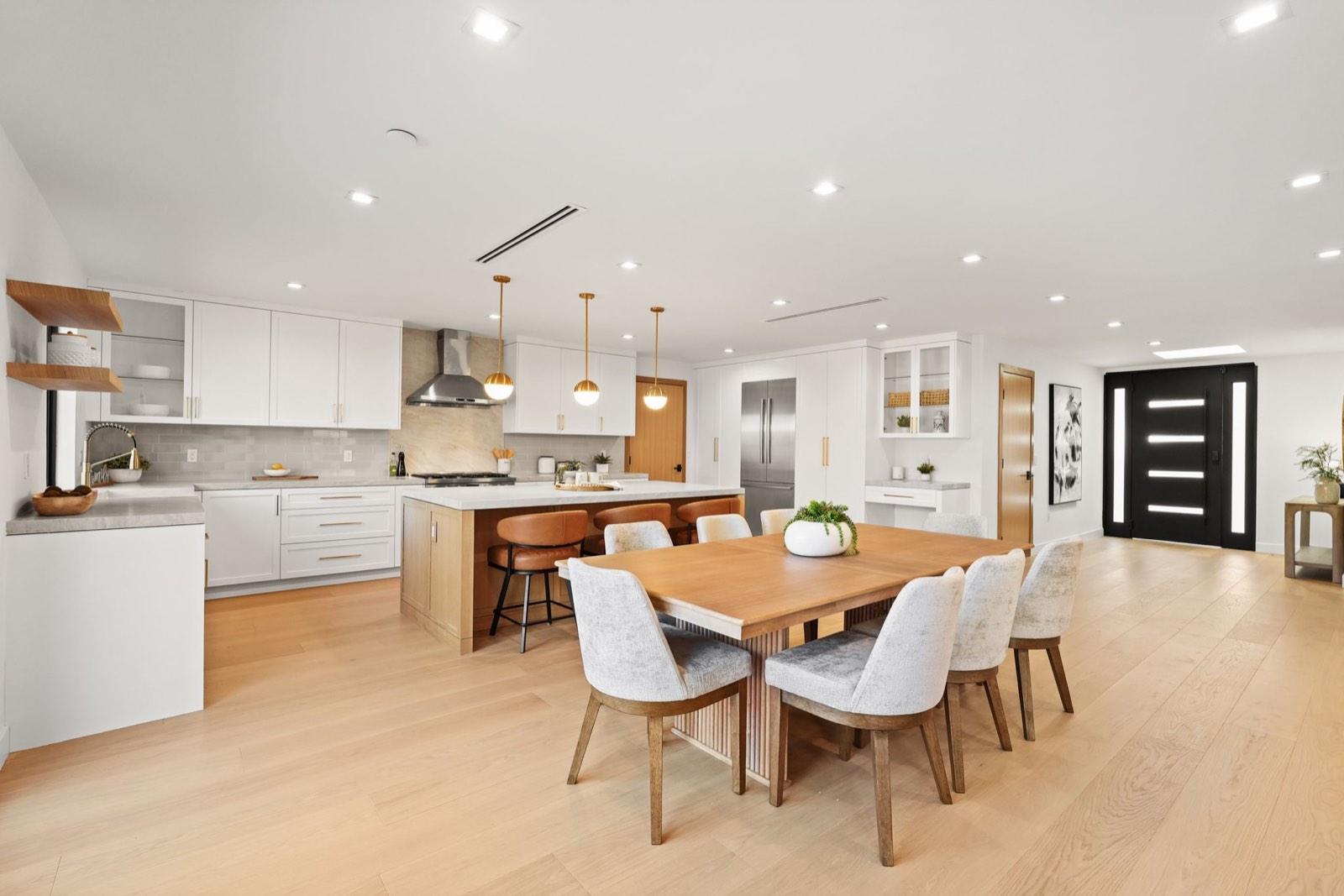 Dining table and kitchen seen together across the open plan
