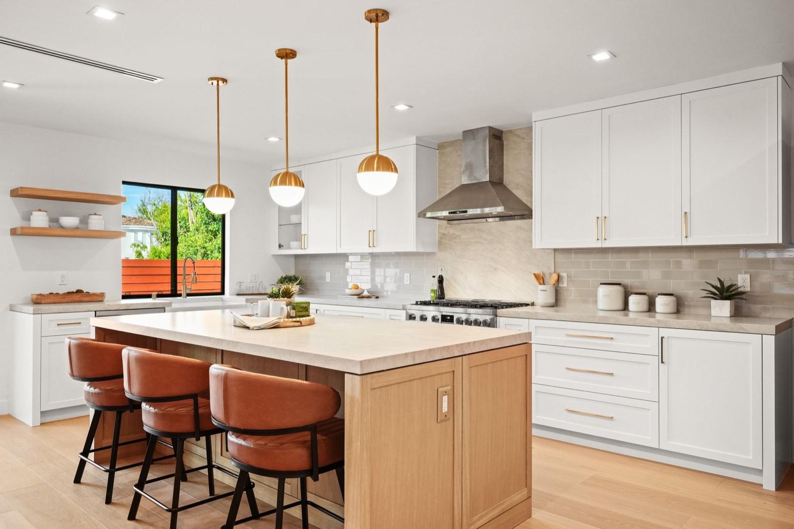 Kitchen island with pendant lighting at an Encino remodeled residence