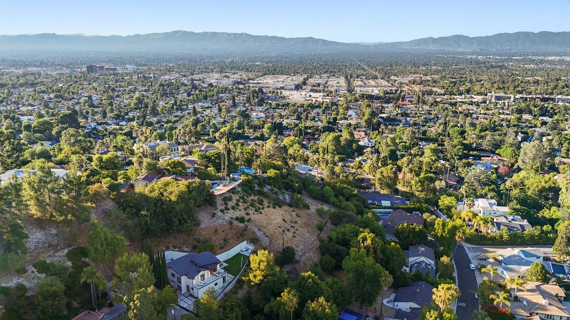 Aerial view from a hillside home on the Encino hillside residence in Encino, looking out across the San Fernando Valley toward the mountains