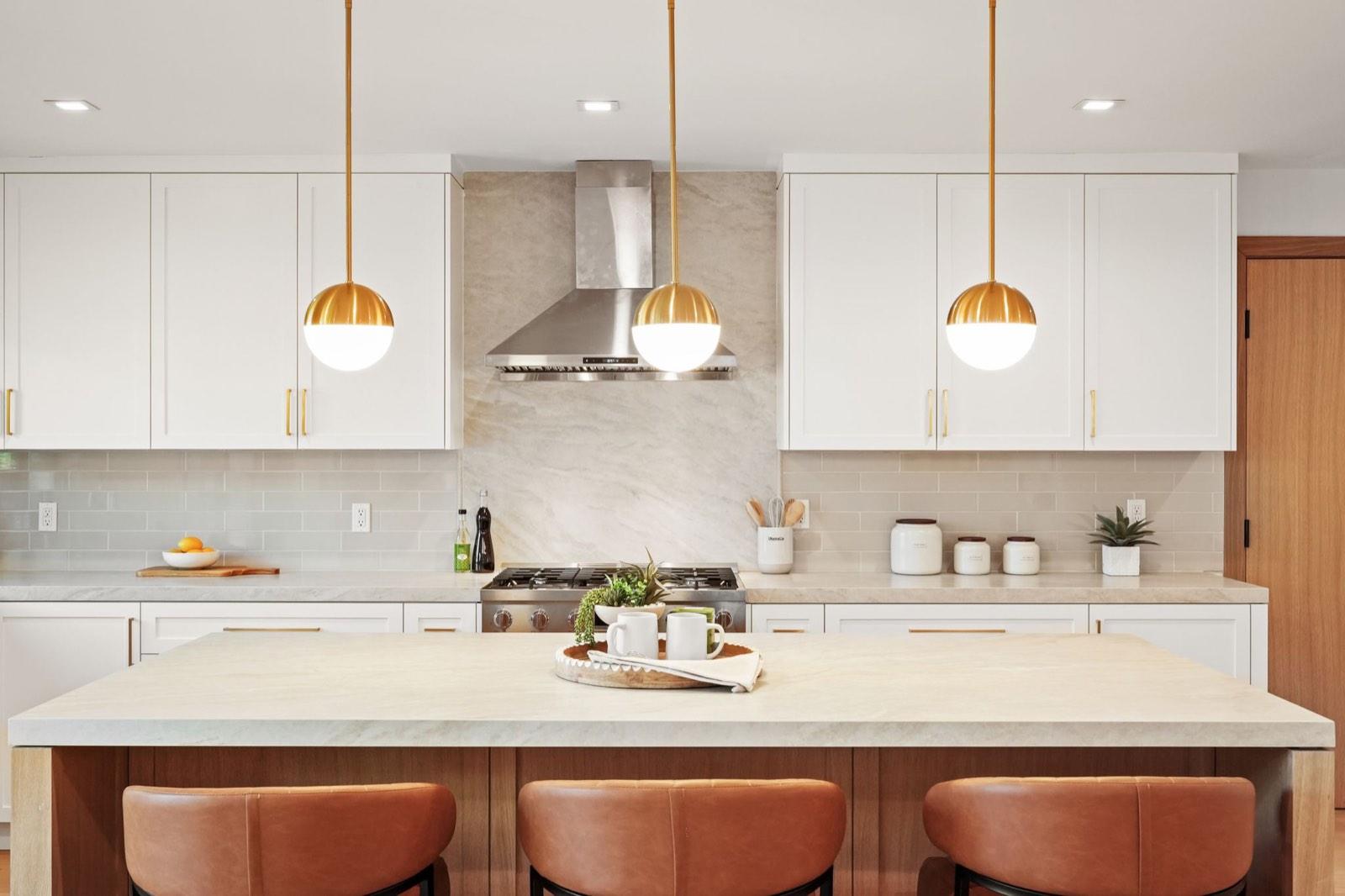 Remodeled kitchen at an Encino remodeled residence, with a white quartz island and counter seating